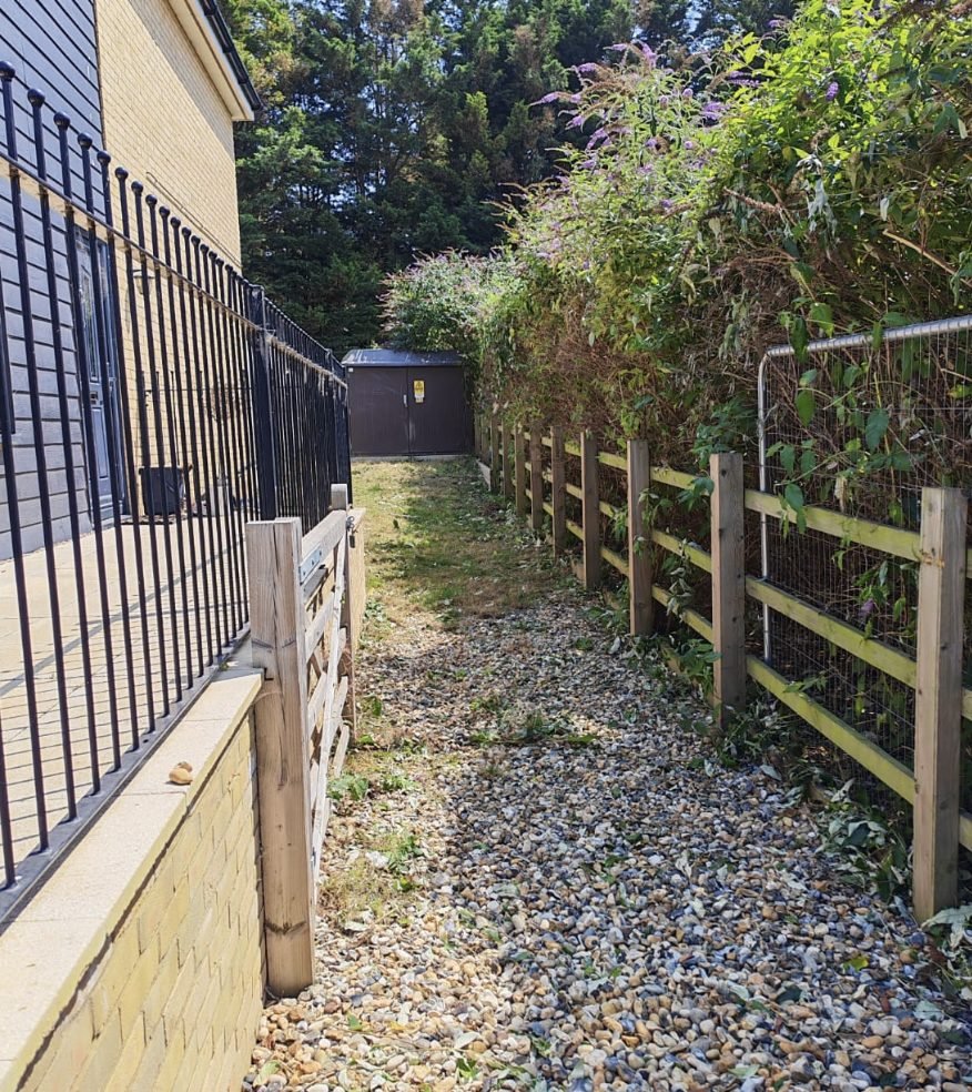 The same alley cleared, with the gravel path open and walkable again