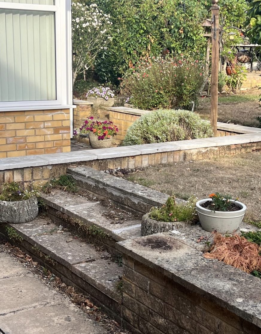 Steps and wall base cleared of weeds at a domestic property